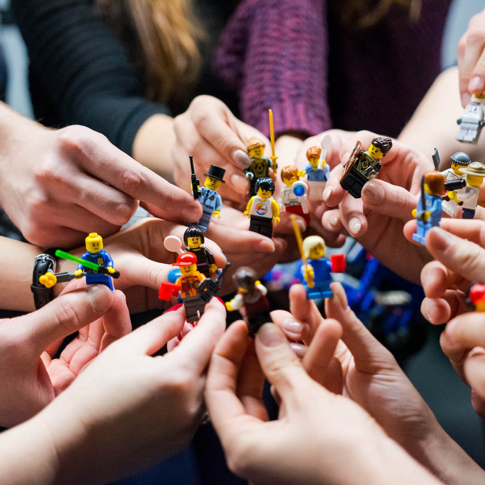 Hands holding different minifigures
